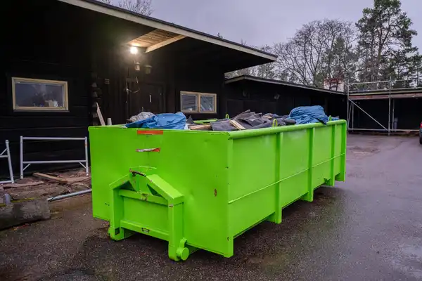 Professional team providing business waste removal services at a shopfront in Sale, UK