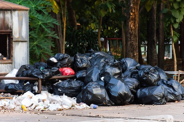 Rubbish bags being collected outside a residential property by a local removal team in Sale